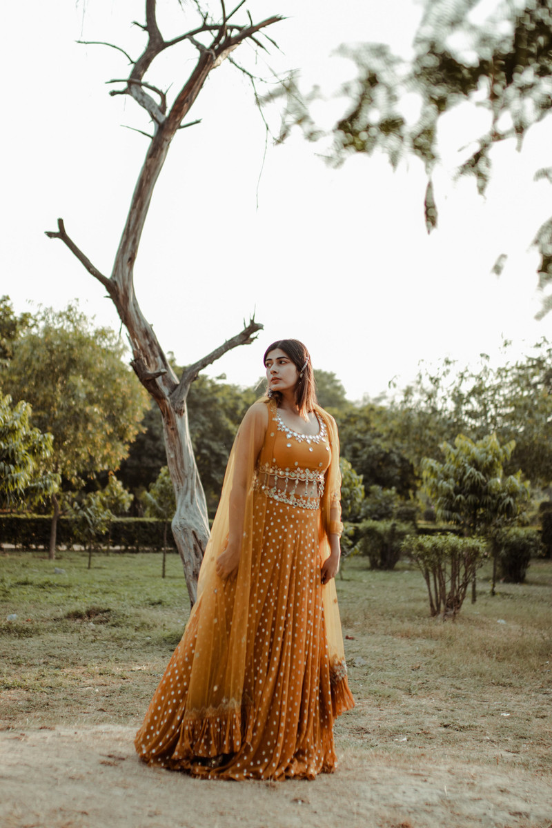 The marigold lehenga, full length in the park.