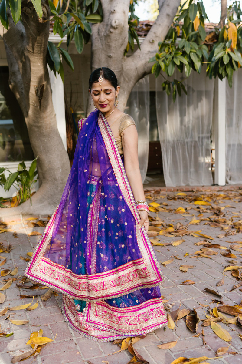 A blue and pink patola-border lehenga with a dupatta.