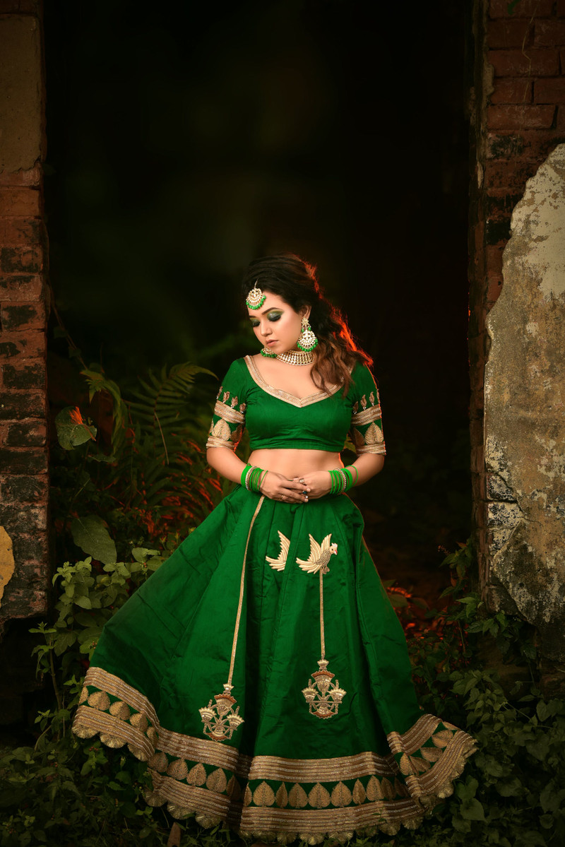 The emerald lehenga, the skirt held out.