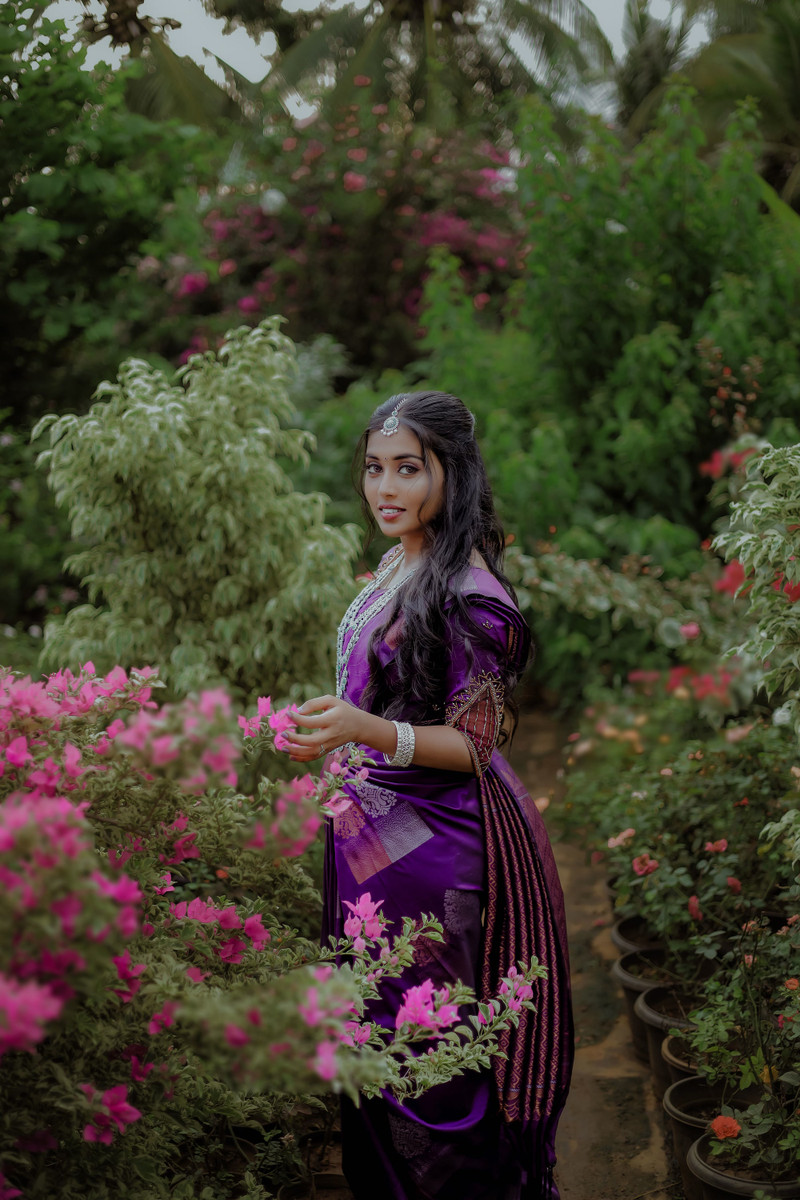 The lilac saree among the flowers.