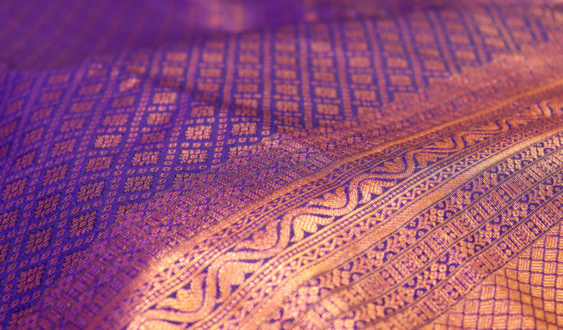 A silk saree's woven border, close.