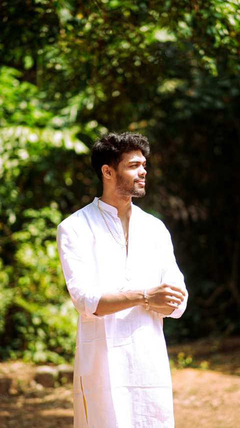 A white cotton kurta set among trees.