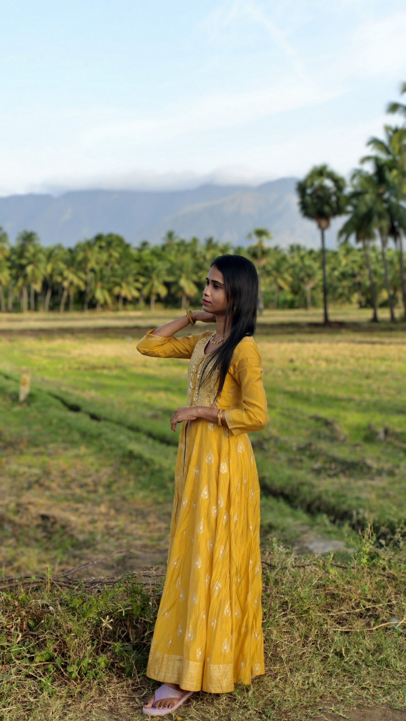 The yellow kurta set, full length in the field.