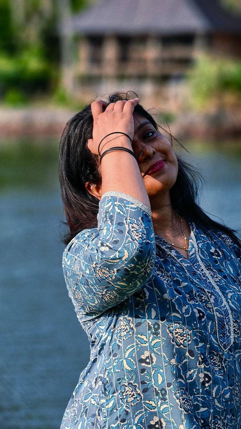 The indigo kurta, a hand in the hair.